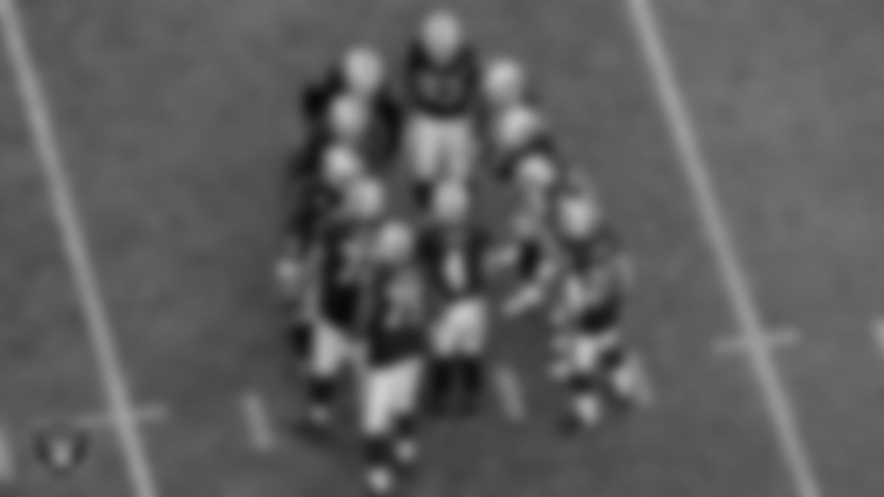 The Las Vegas Raiders offense huddles during the regular season game against the Denver Broncos at Allegiant Stadium.