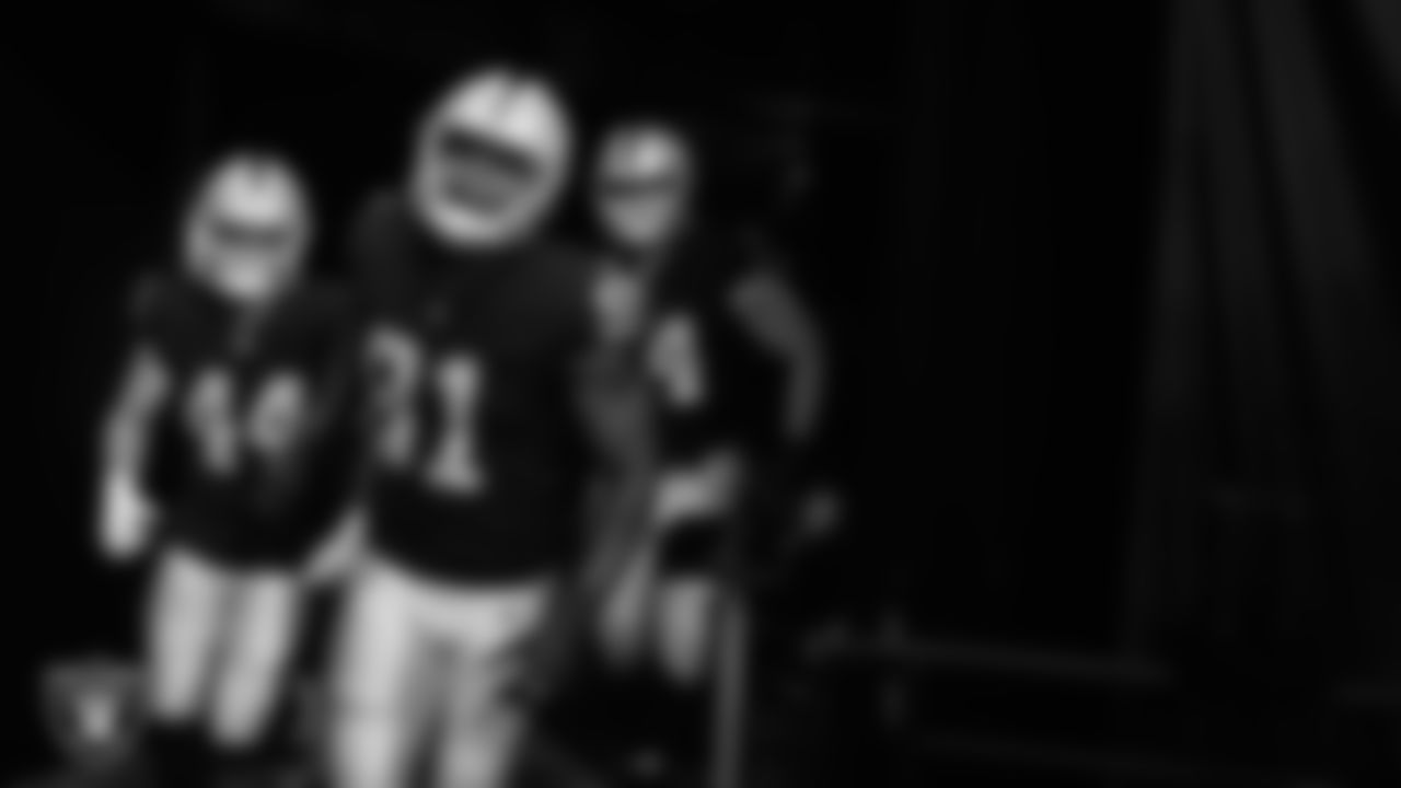 Las Vegas Raiders linebacker Nick Kwiatkoski (44), defensive end Yannick Ngakoue (91) and tackle Kolton Miller (74) walk down the tunnel before the preseason home game against the Seattle Seahawks at Allegiant Stadium.