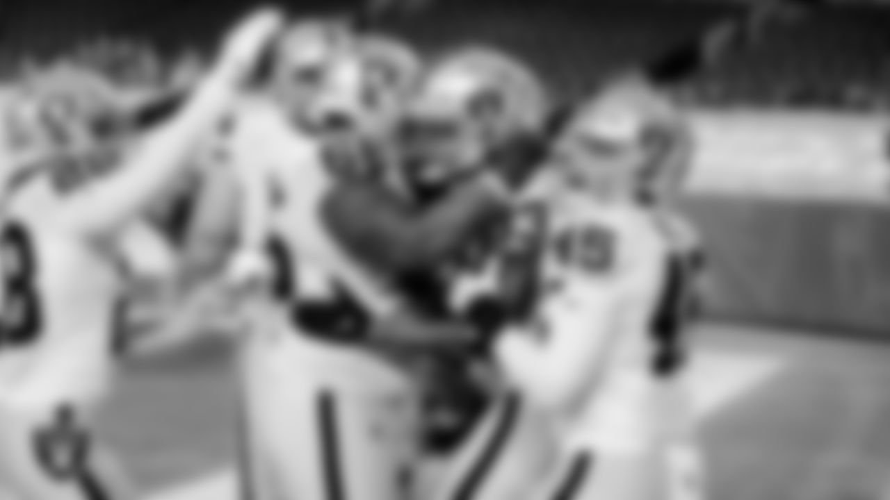 Las Vegas Raiders tight end Darren Waller (83) celebrates with teammates after making a 2-point conversion during the regular season game against the Denver Broncos at Empower Field at Mile High.