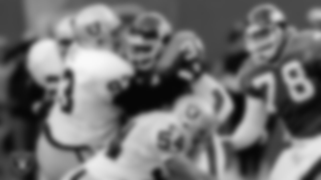 Los Angeles Raiders defensive tackle Jerry Ball (93) and linebacker Greg Biekert (54) make a tackle during the regular season away game against the New York Giants at Giants Stadium, Sunday, November 12, 1995, in East Rutherford, N.J.
