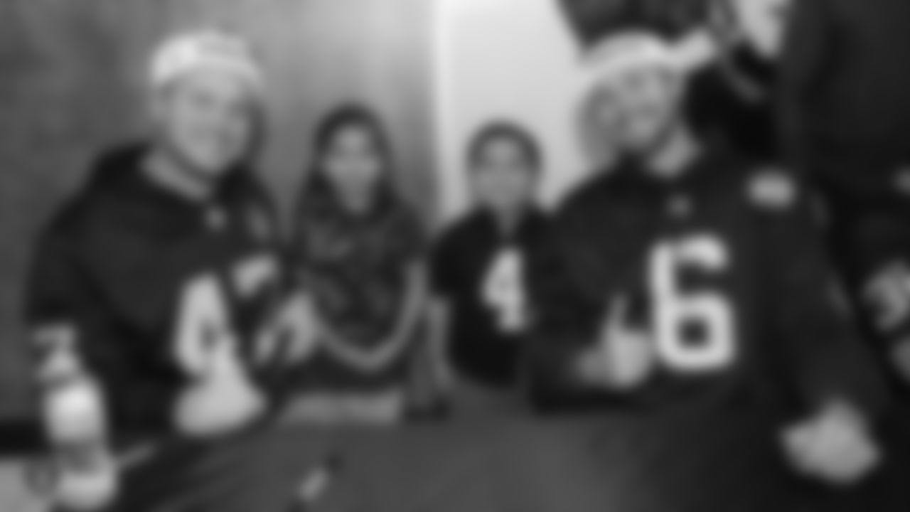 Raiders long snapper Trent Sieg (47) and punter AJ Cole (6) pose for a photo with young fans during the Raiders Foundation's Toys for Tots drive.