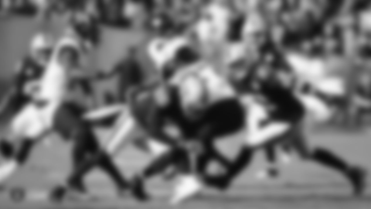 Raiders cornerback Nevin Lawson (26) and linebacker Will Compton (51) make a tackle during the regular season game against the Jacksonville Jaguars.