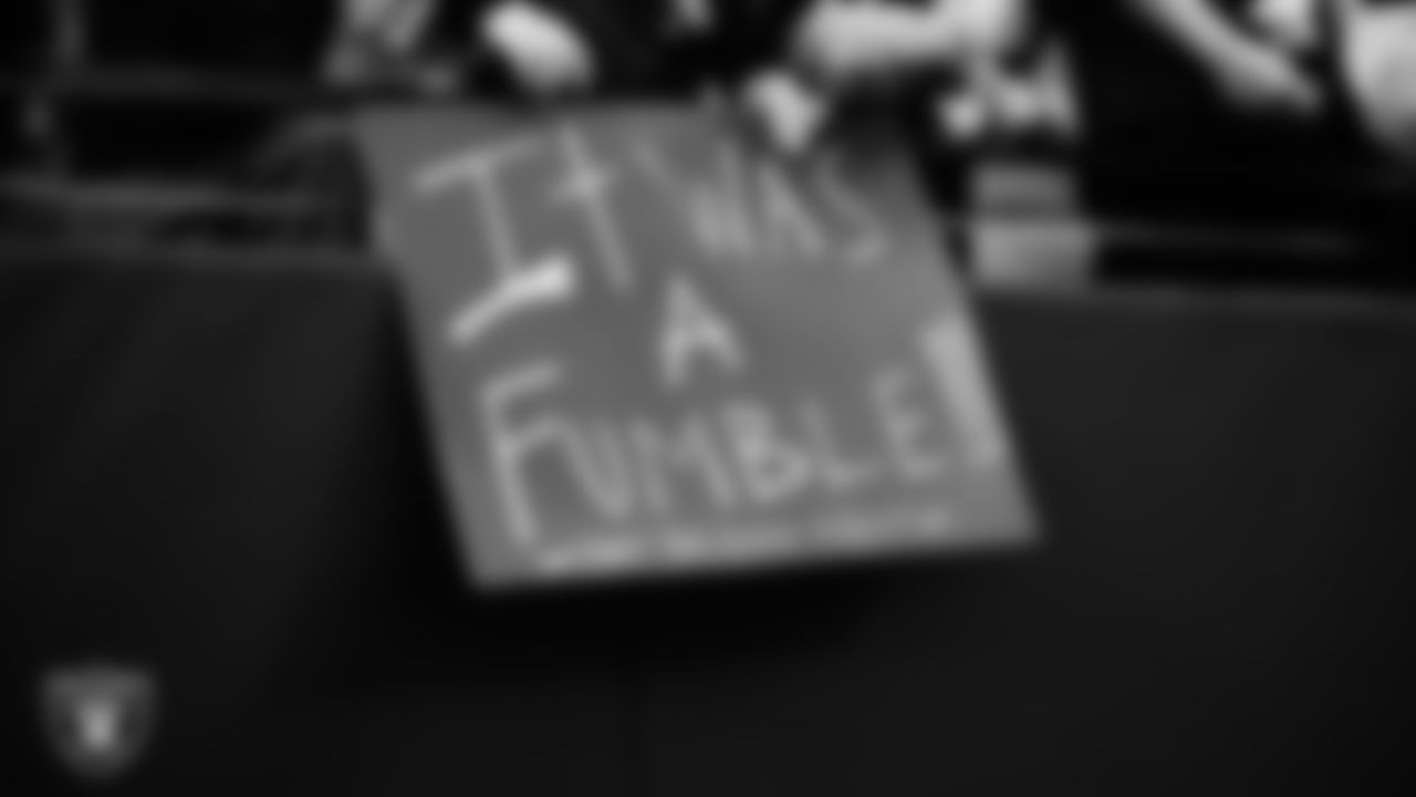 Las Vegas Raiders fans with signs before the regular season home game against the New England Patriots at Allegiant Stadium.