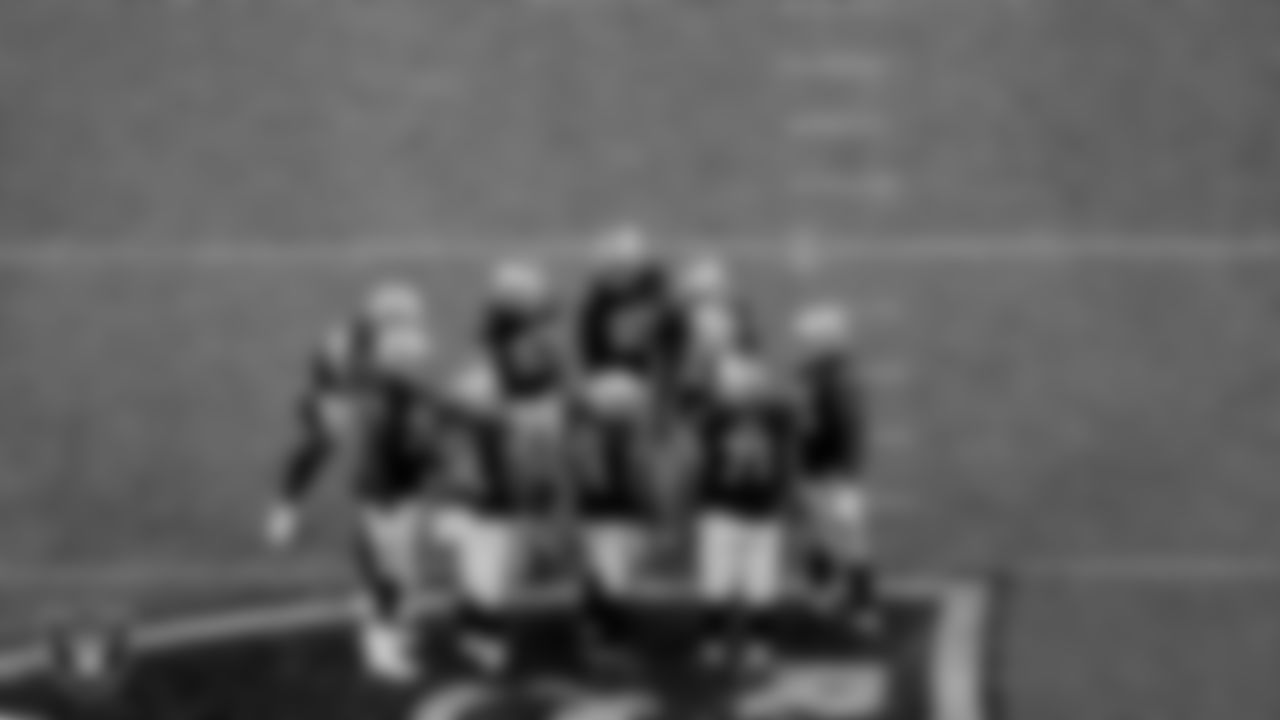 The Las Vegas Raiders offense huddles during the regular season game against the Denver Broncos at Allegiant Stadium.