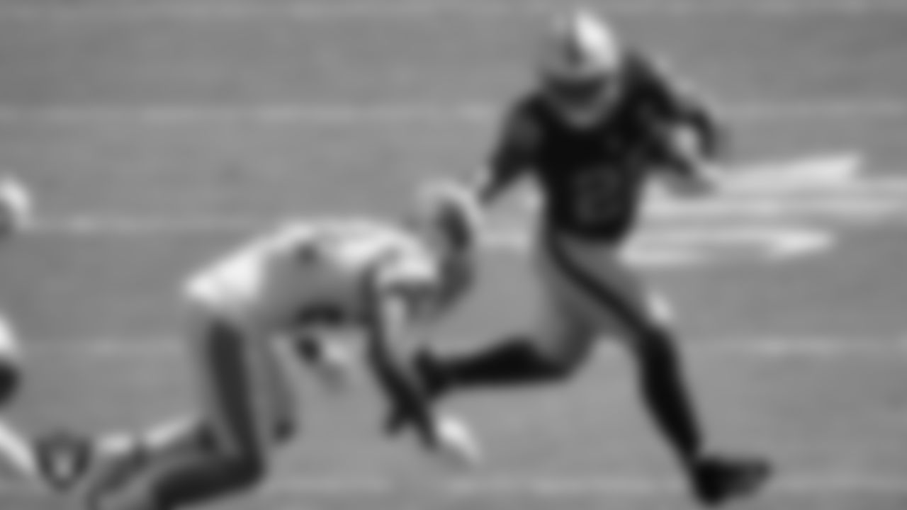 Las Vegas Raiders running back Josh Jacobs (28) stiff arms the defender during the regular season away game against the Carolina Panthers.