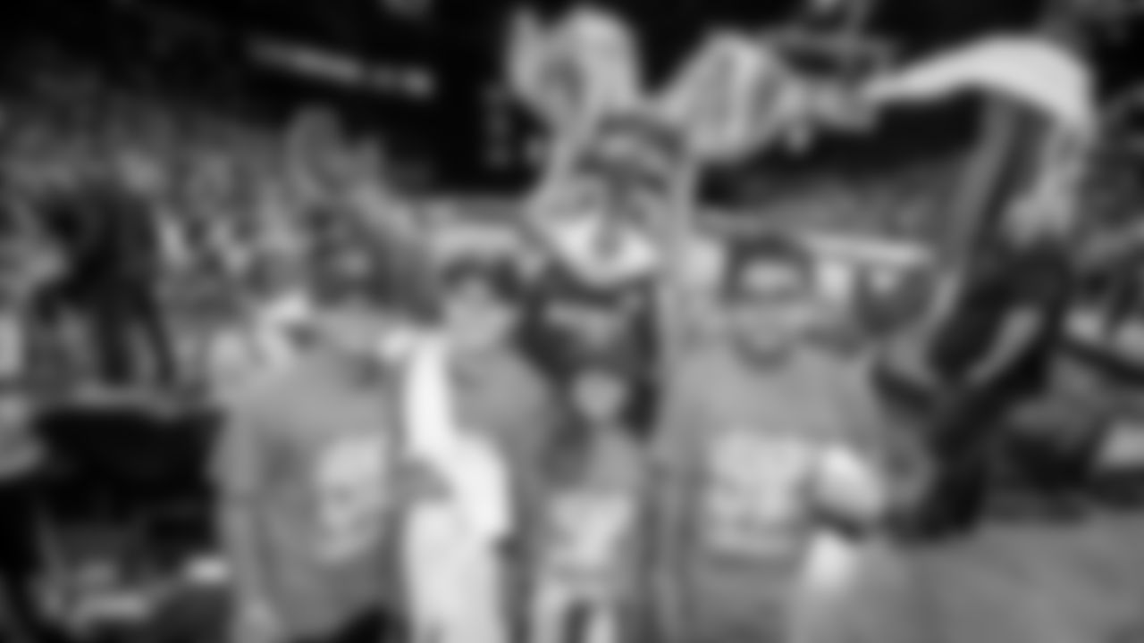 Youth from Southern Nevada pose for a photo with the Las Vegas Aces mascot during a Las Vegas Aces WNBA game.