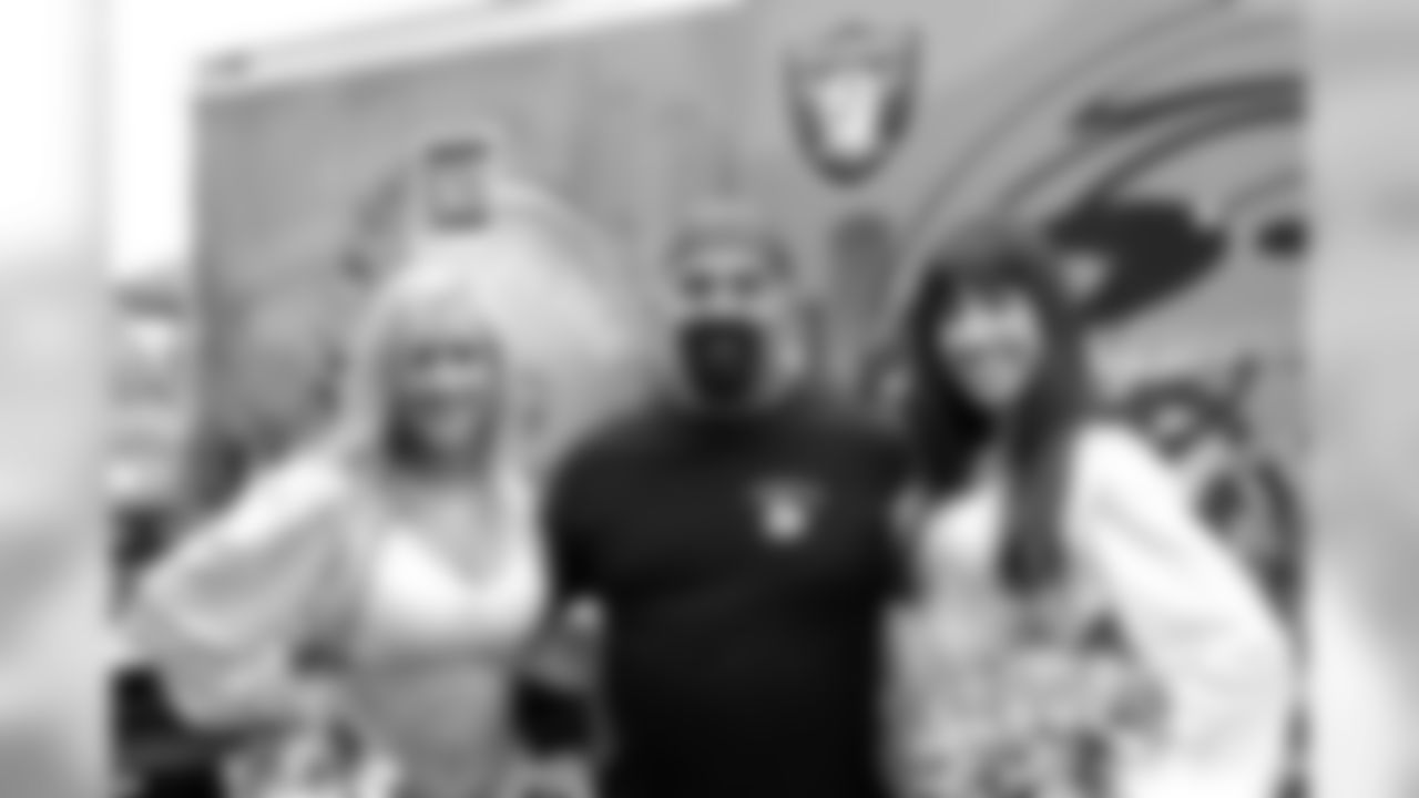 Raiderettes Jonni and Ashley pose for a photo with Bad Boyz of BBQ pitmaster Kirk Bronsord. Photo by Tony Gonzales.