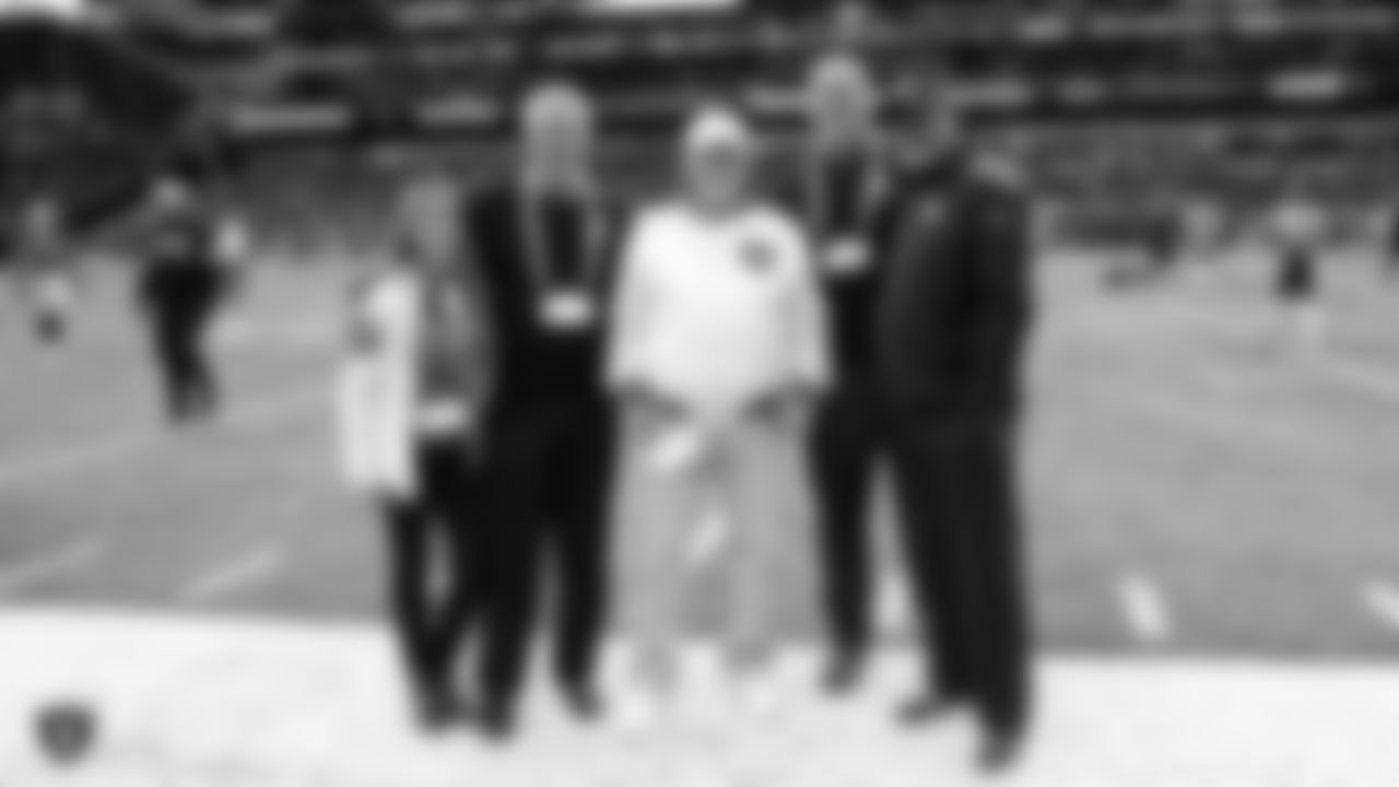 Raiders alumni Mark van Eeghen, Steve Wisniewski, George Atkinson, and Owner Mark Davis pose for a photo on the sidelines before the regular season game against the Chicago Bears at Tottenham Hotspur Stadium.