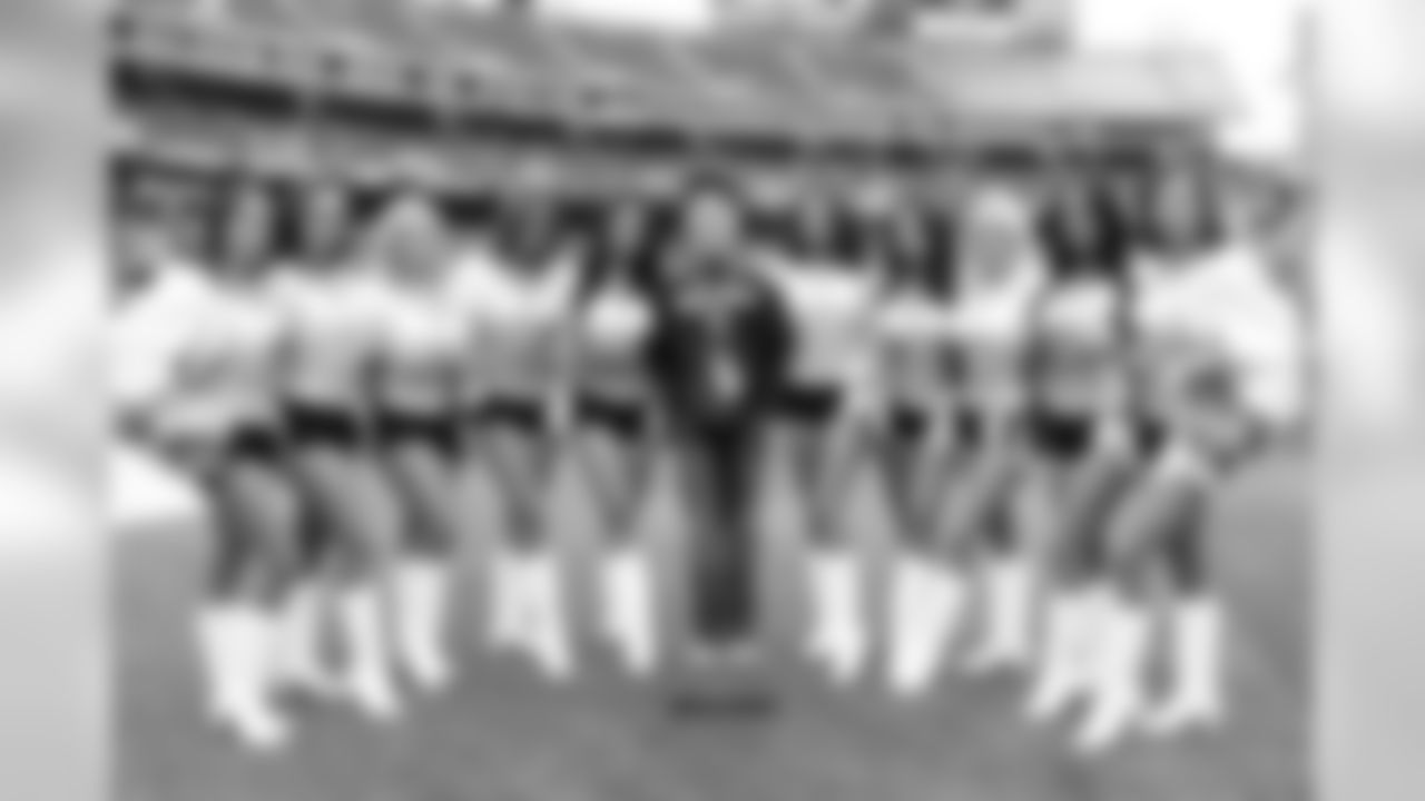 The Raiderettes pose for a photo with Frank Castodio, who had his wish fulfilled by Make A Wish Foundation and the Raiders.