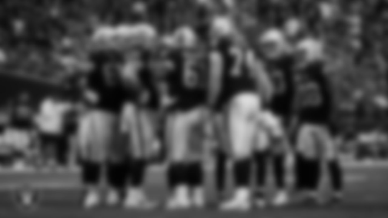 The Las Vegas Raiders offense huddles during the regular season home game against the New England Patriots at Allegiant Stadium.