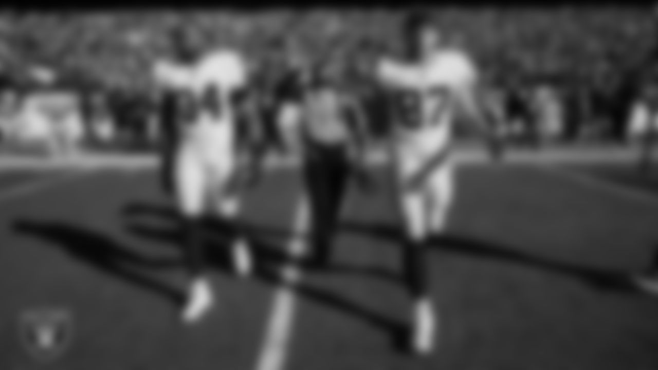 Las Vegas Raiders linebacker K.J. Wright (34) and tight end Foster Moreau (87) walk out to the center of the field for the coin toss before the regular season away game against the the Kansas City Chiefs.