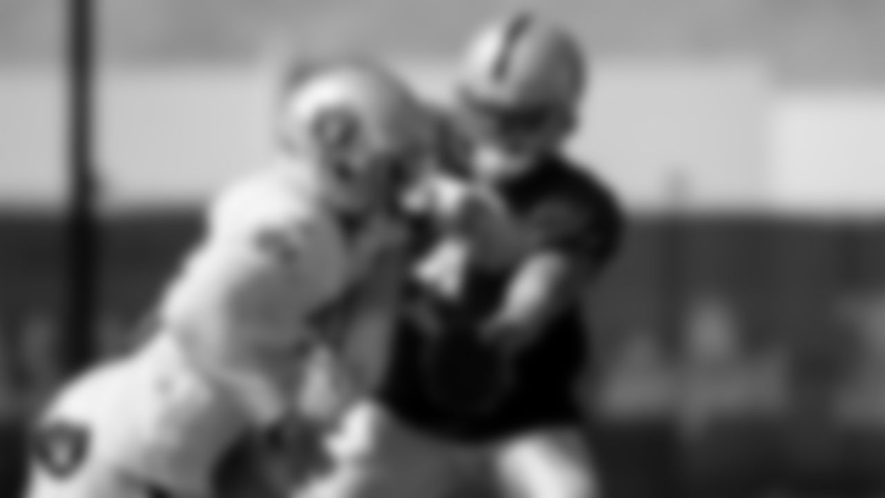 Las Vegas Raiders running back Zamir White (35) and quarterback Derek Carr (4) during practice at Intermountain Healthcare Performance Center.