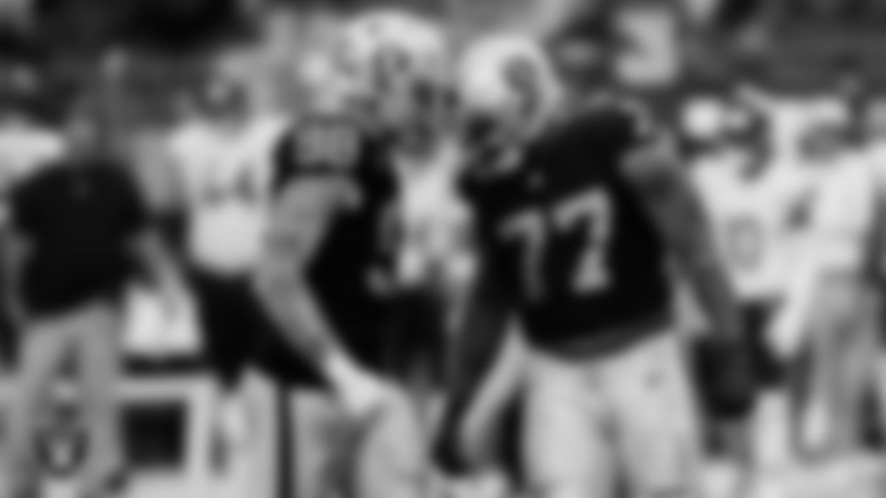 Las Vegas Raiders defensive tackle Quinton Jefferson (77) celebrates with defensive end Maxx Crosby (98) after making a tackle during the regular season home game against the Chicago Bears.