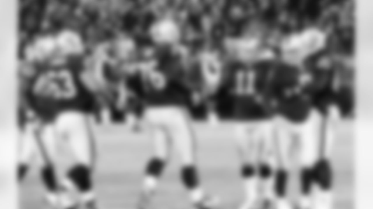 The special teams unit runs over to Janikowski after he makes another field goal.
