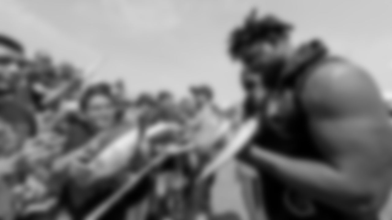 Oakland Raiders defensive end Mario Edwards Jr. (97) signs autographs for fans after practice at 2018 Training Camp at The Oakland Raiders Napa Valley Training Complex, Sunday, July 29, 2018, in Napa, California.