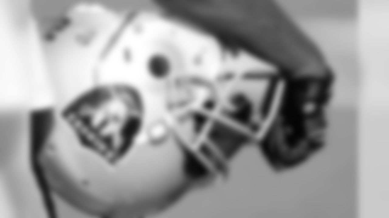 One of the Raiders holding their helmet in their arm. Photo By Tony Gonzales