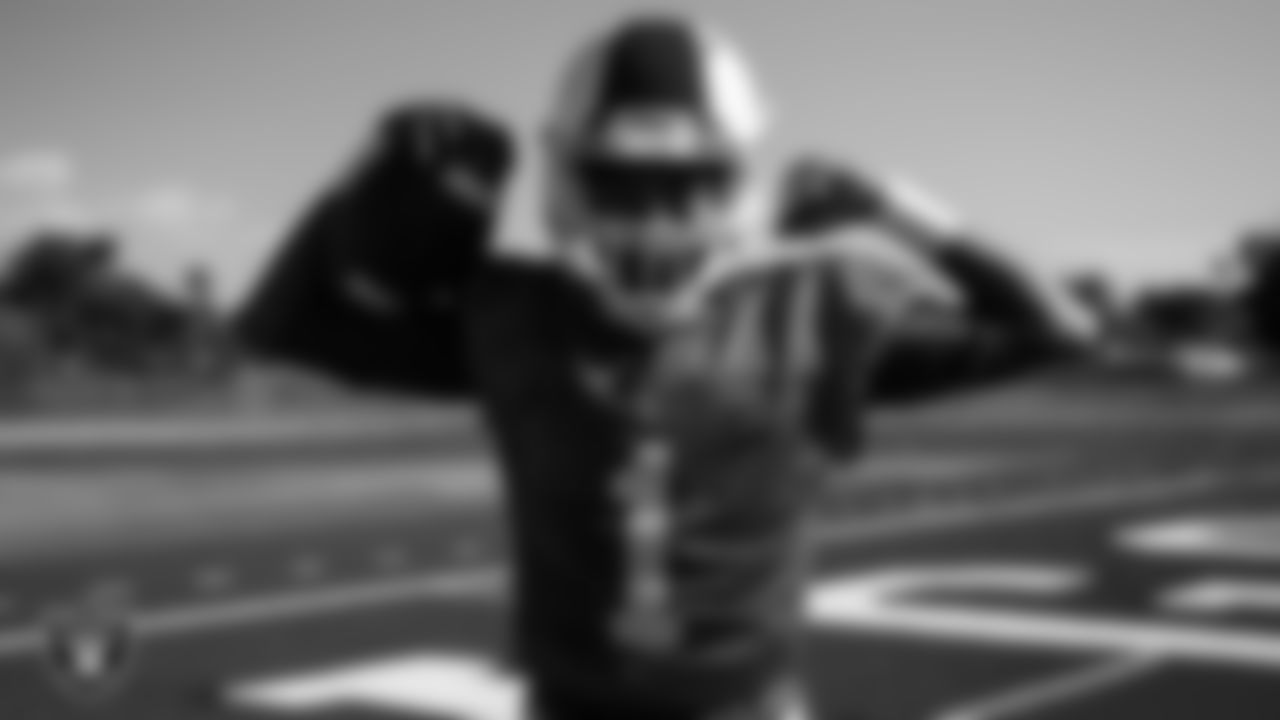 A member of the Valley High School football team poses with a new helmet.