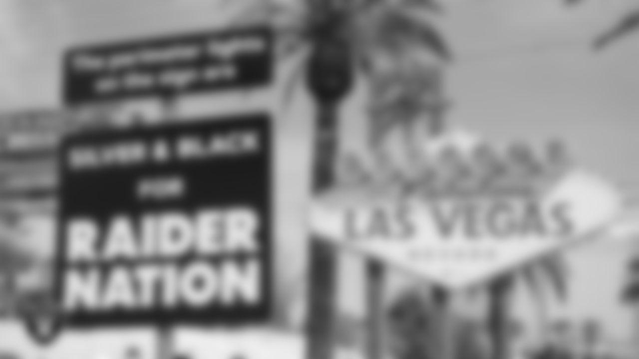 Las Vegas Raiders signage in front of the "Welcome to Fabulous Las Vegas" sign before it was lit up silver and black.