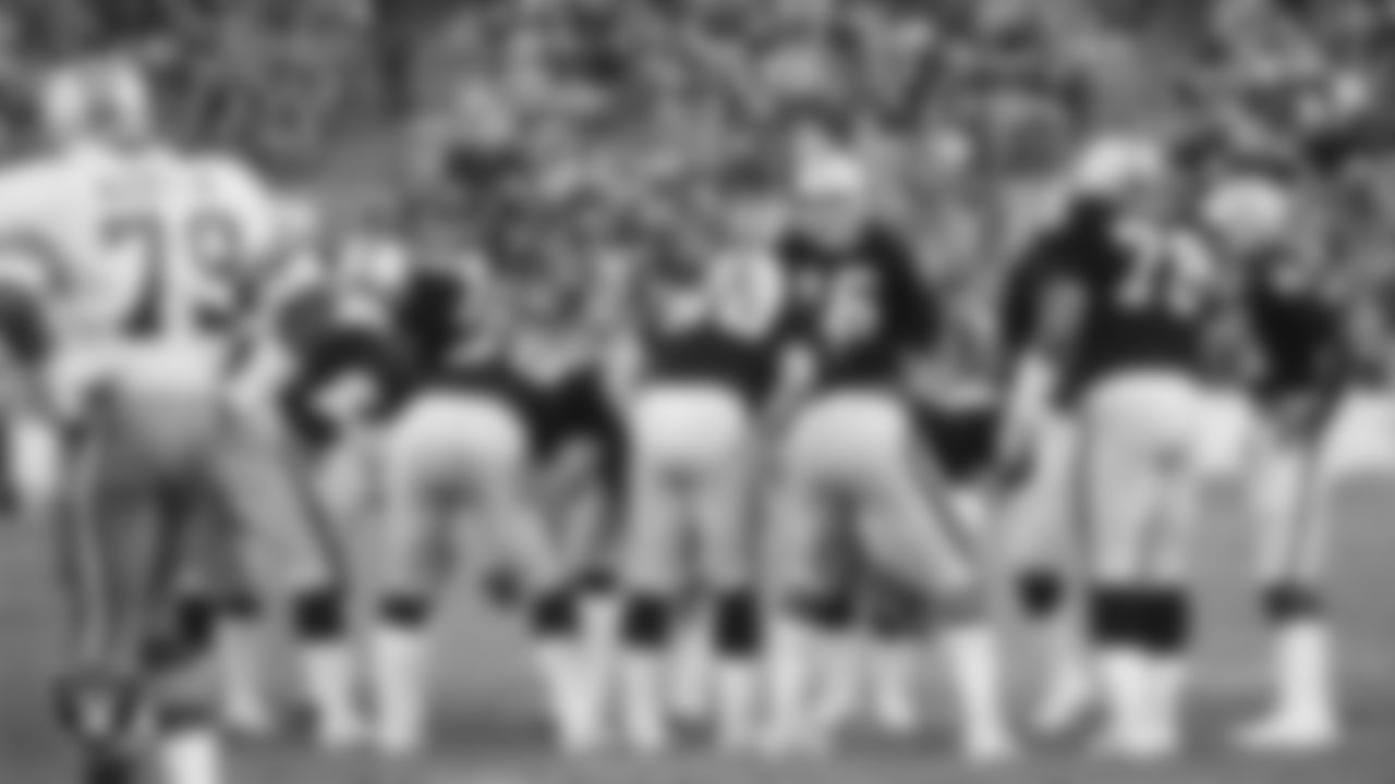 Oakland Raiders quarterback Jim Plunkett (16) calls a play in the huddle during the regular season home game against the Dallas Cowboys at Oakland–Alameda County Coliseum, Sunday, December 7, 1980, in Oakland, Calif.