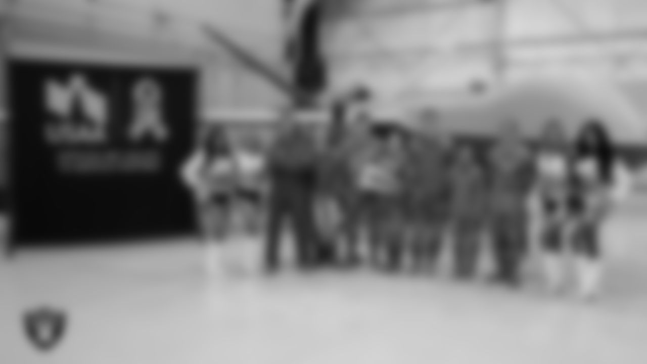 Raiderettes Audrey, Jennifer, Taylor and Monica D. pose for a photo with Air Force members from Creech Air Force Base at Creech Air Force Base.