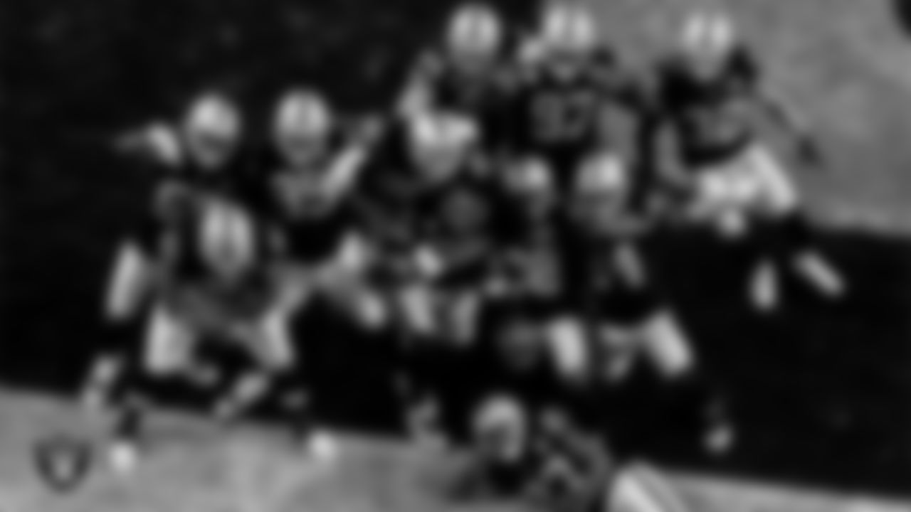 The Las Vegas Raiders celebrate after cornerback Nevin Lawson (26) recovered a fumble during the regular season home game against the Denver Broncos.