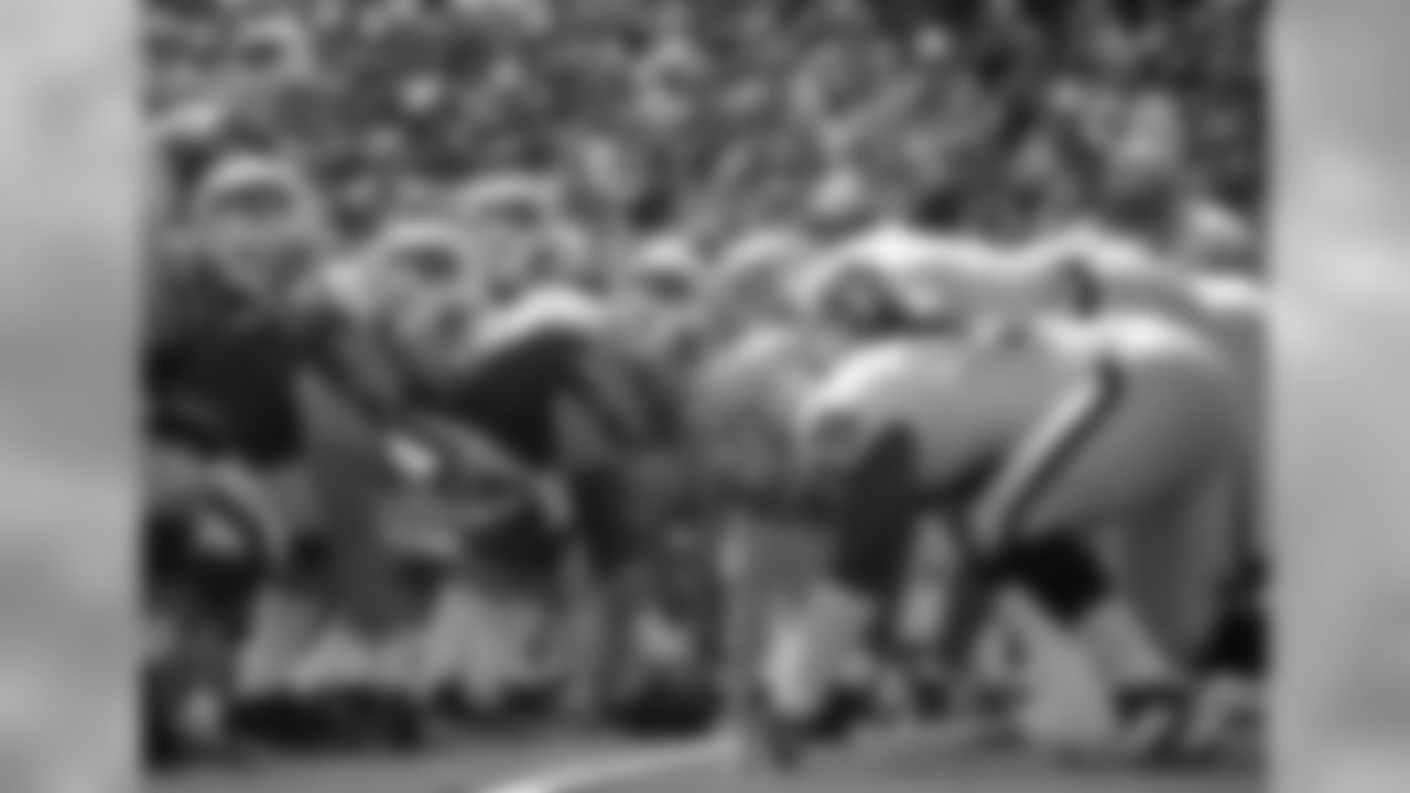 The Oakland defensive line gets ready for the play.