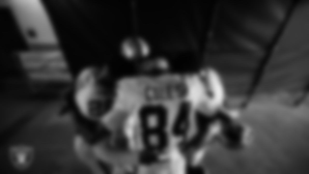 The Las Vegas Raiders returners huddle in the tunnel before the regular season away game against the Denver Broncos at Empower Field at Mile High.