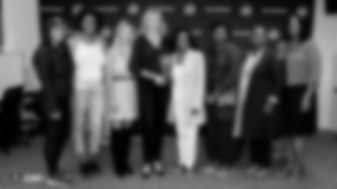 Members of the Raiders Women's Association and A Safe Place pose for a photo during a ceremony that presents the Raiders Women's Association with A Safe Place's Community Champions Award.