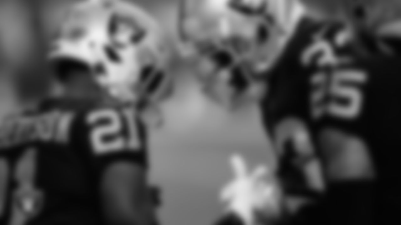 Las Vegas Raiders cornerback Amik Robertson (21) and safety Roderic Teamer (33) celebrate on the field during the regular season home game against the San Francisco 49ers at Allegiant Stadium.