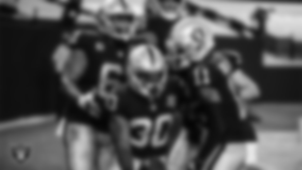 Las Vegas Raiders running back Jalen Richard (30) is congratulated by center Rodney Hudson (61) and wide receiver Henry Ruggs III (11) after rushing for a 20-yard touchdown during the regular season home game against the New Orleans Saints.