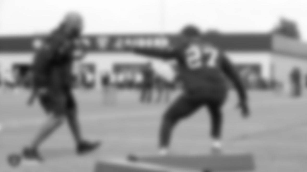 Raiders assistant defensive backs coach Taver Johnson and cornerback Trayvon Mullen (27) at a workout during phase two of the offseason program at the Raiders Practice Facility in Alameda, Calif.