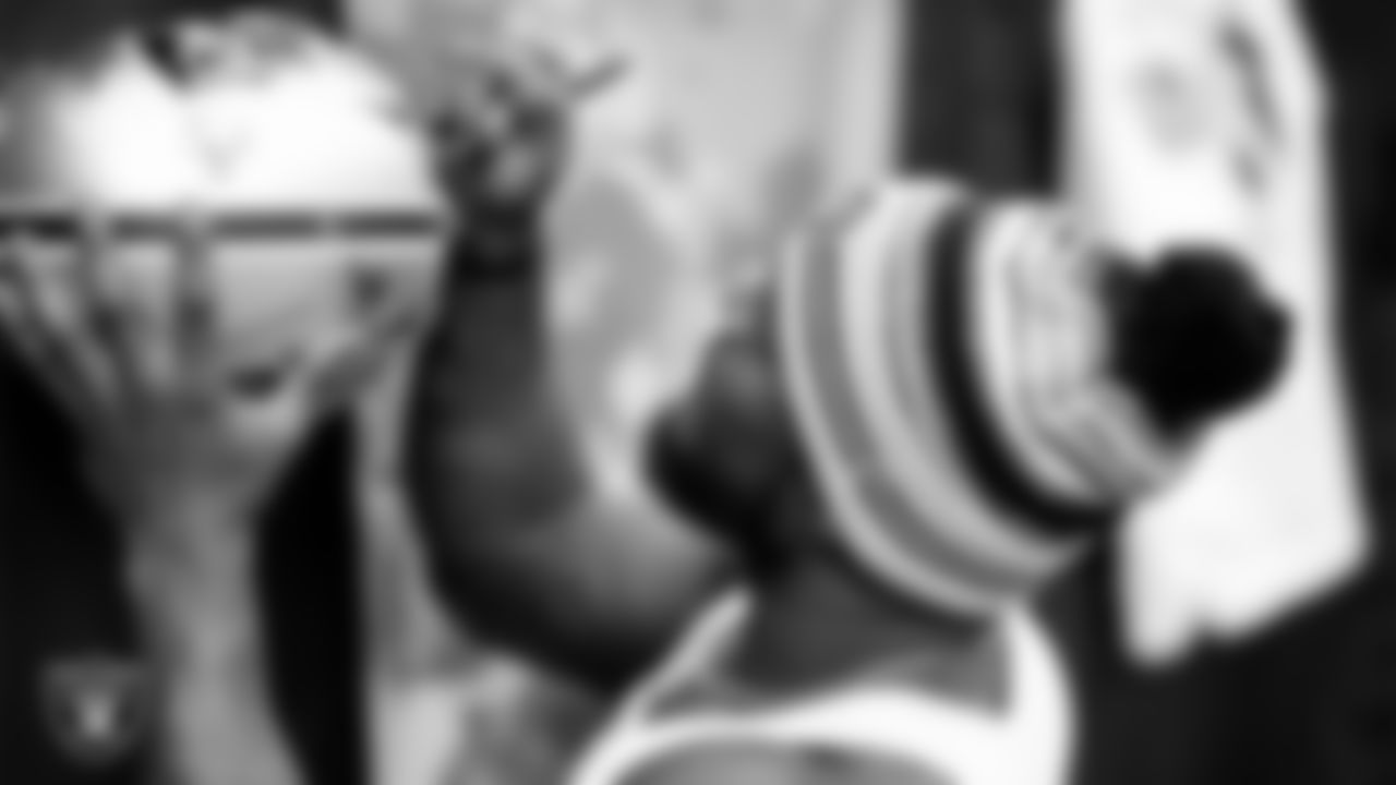 Las Vegas Raiders linebacker Denzel Perryman (52) signs autographs for fans before the regular season home game against the Indianapolis Colts at Allegiant Stadium.