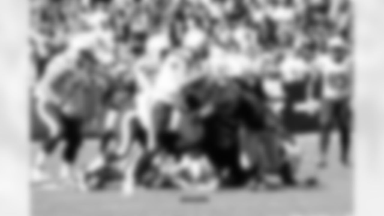 DE Justin Tuck dives for QB Philip Rivers.