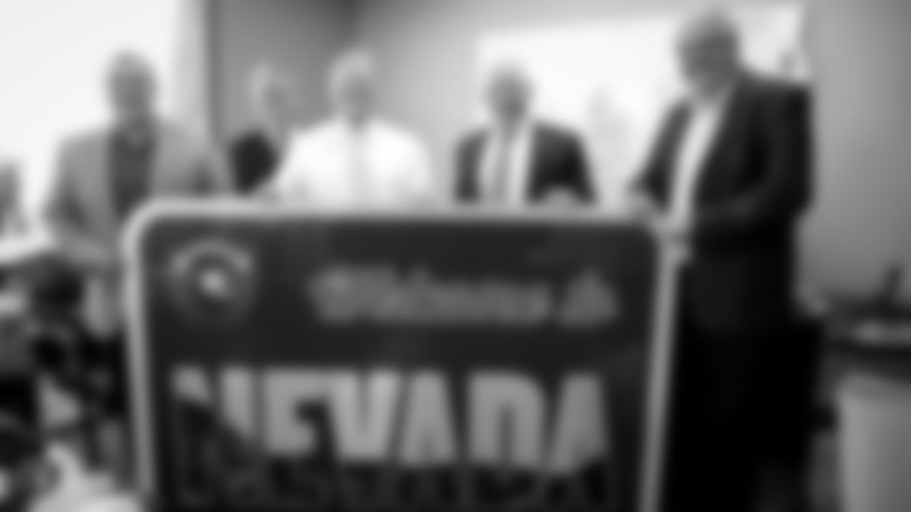 Raiders executive vice president and general counsel Dan Ventrelle, President Marc Badain, Owner Mark Davis, special guest Larry Delsen, and Governor of Nevada Steve Sisolak pose for a photo with a welcome to Nevada sign before an official announcement of the Raiders changing their name to the Las Vegas Raiders.