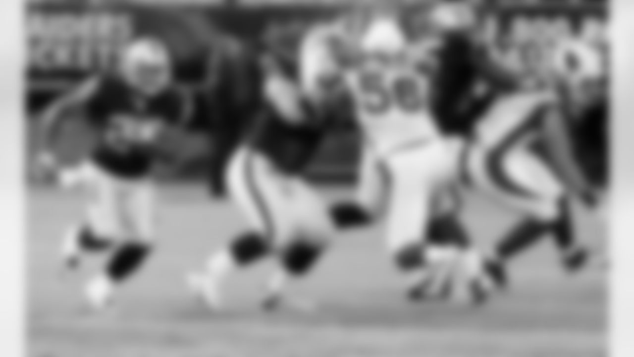 RB Rock Cartwright runs behind the powerful blocking of the offensive line.