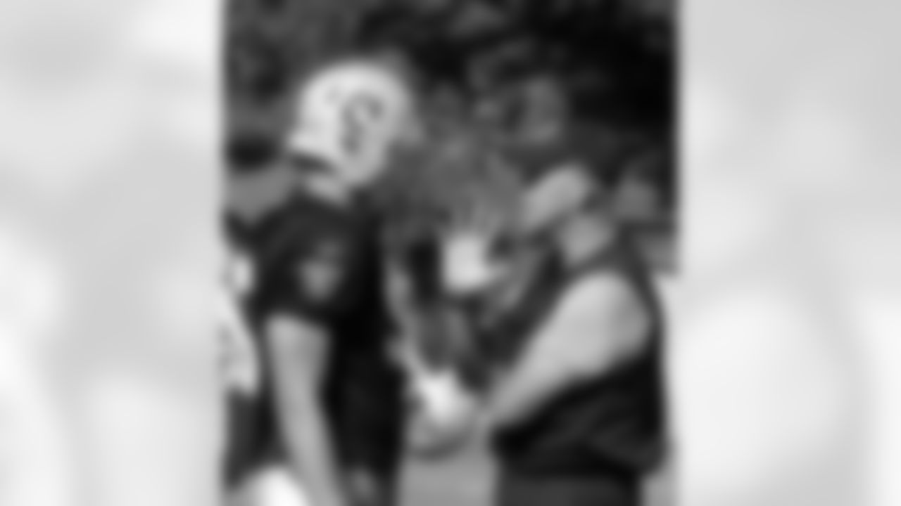 Coach Waufle works with DE Mason Brodine.