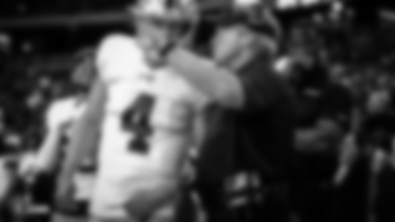 Raiders quarterback Derek Carr (4) talks with Head Coach Jon Gruden before the Raiders preseason game against the Arizona Cardinals.