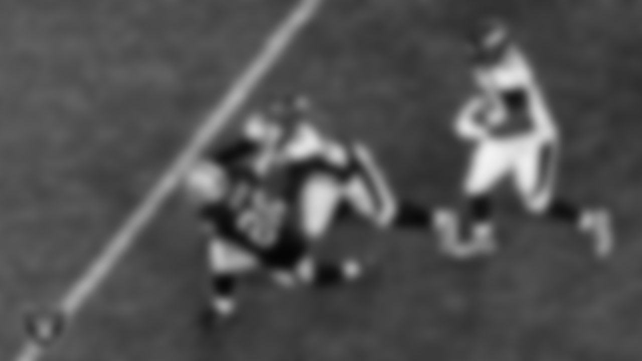 Las Vegas Raiders running back Josh Jacobs (28) stiff arms the defender during the regular season home game against the Denver Broncos.