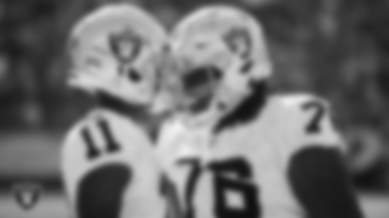 Las Vegas Raiders wide receiver Henry Ruggs III (11) is congratulated by guard John Simpson (76) after making a 61-yard touchdown catch during the regular season away game against the Pittsburgh Steelers.