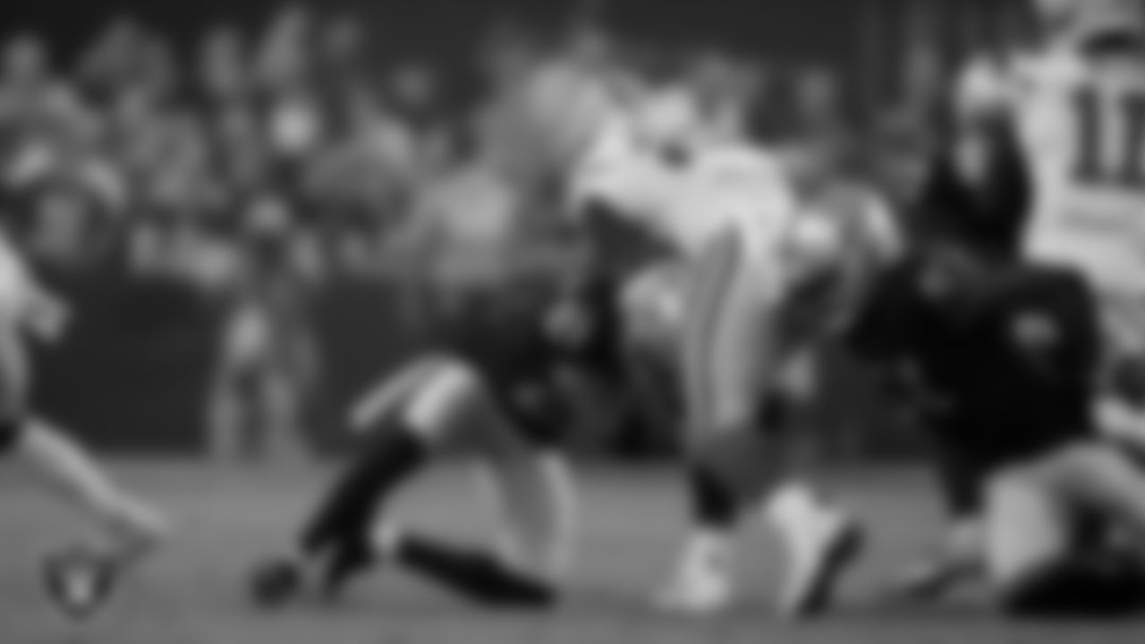 Las Vegas Raiders cornerback Amik Robertson (21) and defensive end Malcolm Koonce (51) during the regular season home game against the Green Bay Packers at Allegiant Stadium.