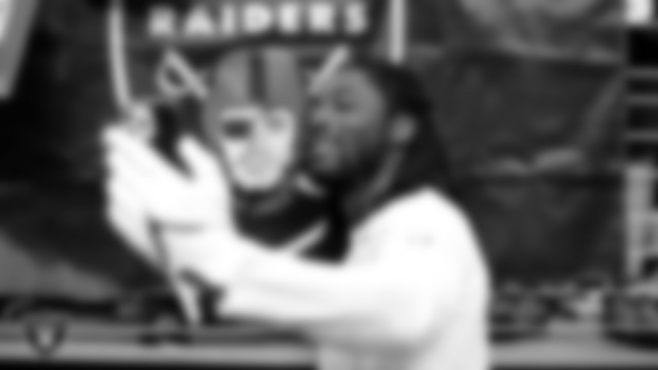 Las Vegas Raiders linebacker Cory Littleton (42) takes a selfie with a fan before the regular season home game against the Denver Broncos.