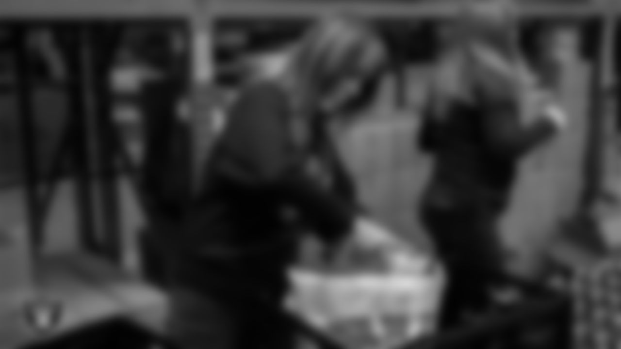 Staff members of the Las Vegas Raiders and ASM pack 600 bags of shelf-stable holiday meals to hand out for Thanksgiving at Three Square Food Bank.
