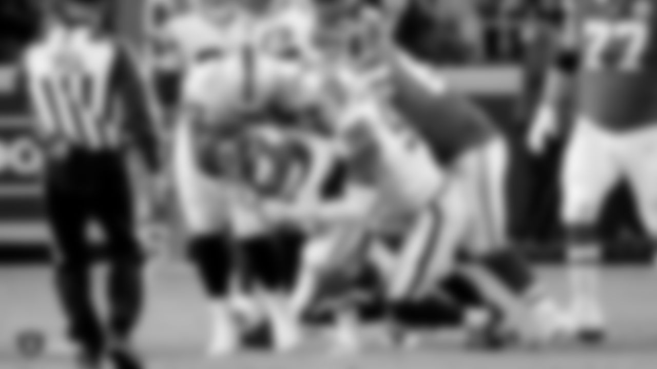 Raiders defensive tackle Johnathan Hankins (90) and defensive end Clelin Ferrell (96) make a tackle during the regular season game against the Kansas City Chiefs.