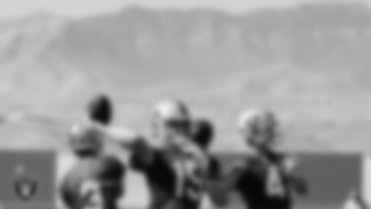 Las Vegas Raiders quarterback Chase Garbers (15) and quarterback Derek Carr (4) during practice at Intermountain Healthcare Performance Center.