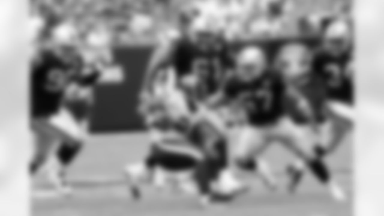 LB Ricky Bronw (57 and company catch the Texans runner in the backfield.