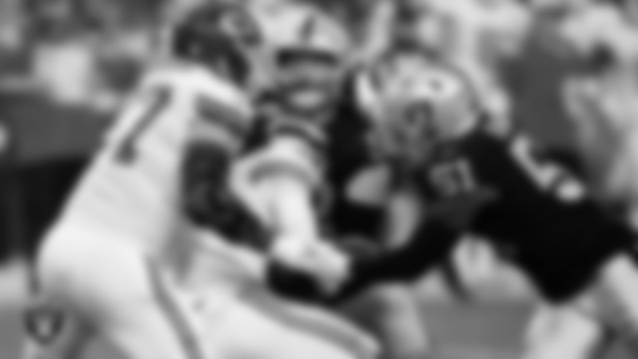 Las Vegas Raiders defensive end Maxx Crosby (98) and defensive end Malcolm Koonce (51) sack the quarterback during the regular season home game against the Kansas City Chiefs at Allegiant Stadium.