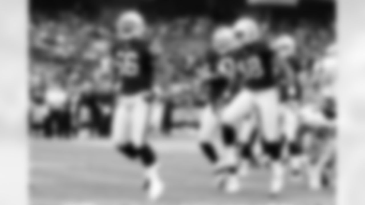 LBs Darryl Blackstock and Bani Gbadyu get pumped up after stopping Mark Ingram.
