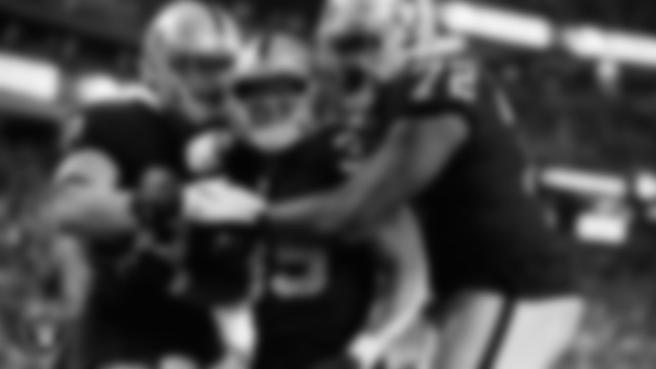 Las Vegas Raiders running back B.J. Emmons (35) is congratulated by tight end Nick Bowers (82) and guard/tackle Jaryd Jones-Smith (72) after rushing for a two-yard touchdown during the preseason home game against the Seattle Seahawks at Allegiant Stadium.