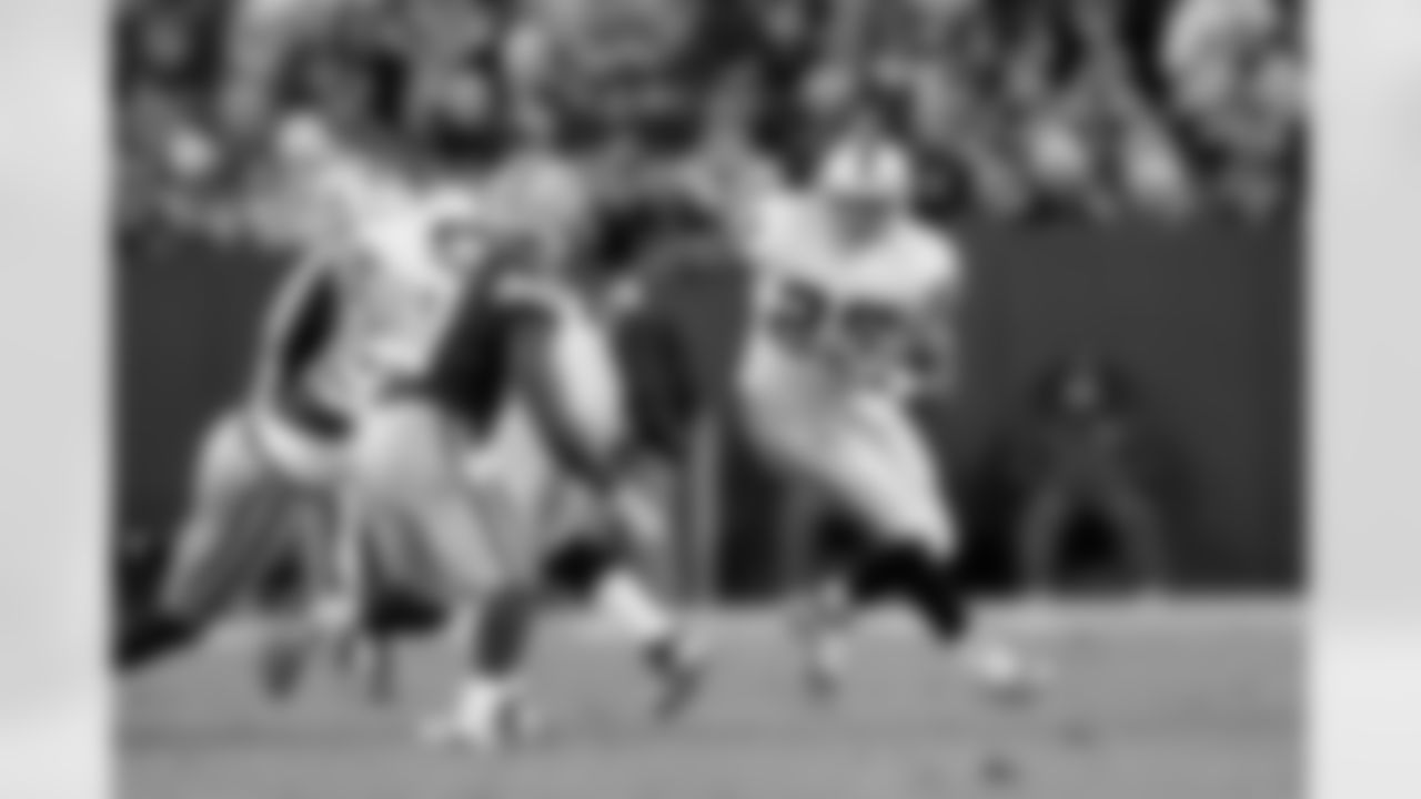 RB MIchael Bush runs around G Cooper Carlisle's block.