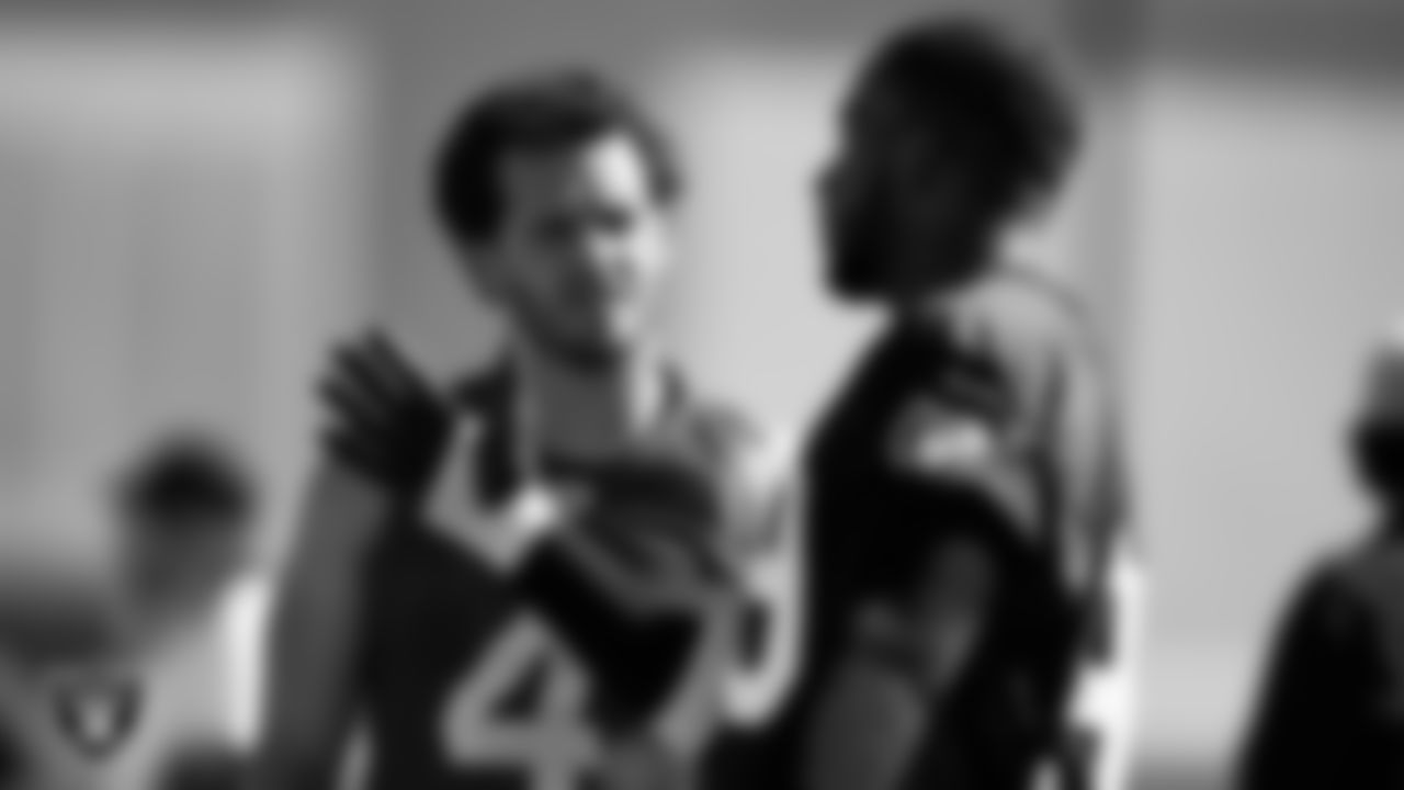 Las Vegas Raiders quarterback Derek Carr (4) and defensive end Clelin Ferrell (99) during practice at Intermountain Healthcare Performance Center.